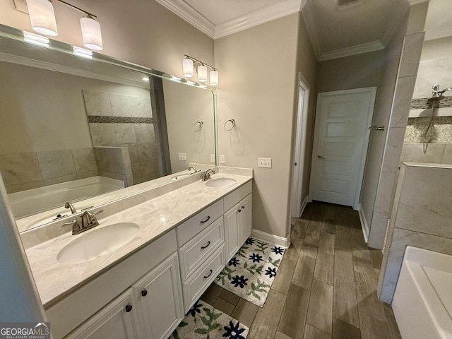 full bath with ornamental molding, a sink, and a bath