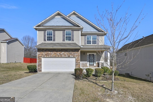 craftsman-style home featuring a porch, an attached garage, stone siding, driveway, and a front yard