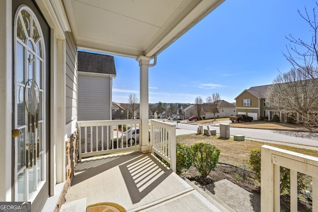 balcony featuring a residential view and a porch