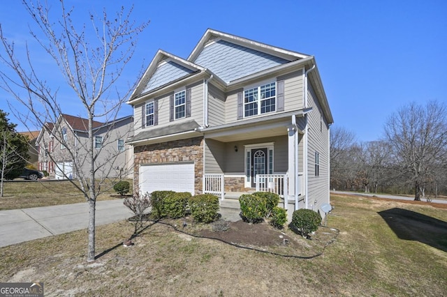 view of front of home with stone siding, covered porch, driveway, and an attached garage