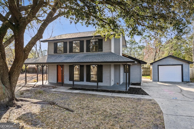 view of front of property with a detached garage, a shingled roof, covered porch, driveway, and an outdoor structure