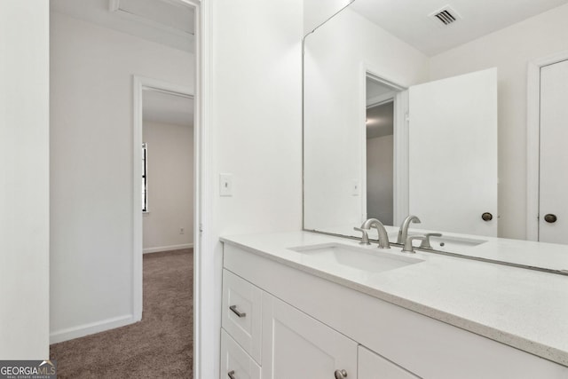 bathroom featuring baseboards, visible vents, and vanity