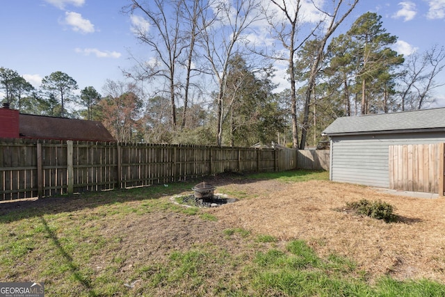 view of yard with an outdoor fire pit and a fenced backyard