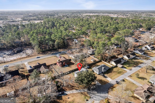 birds eye view of property with a wooded view