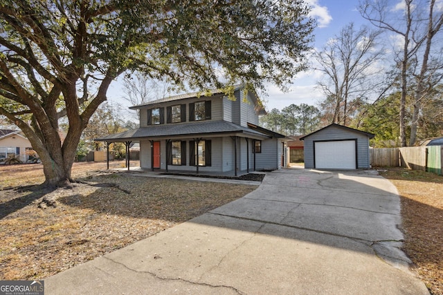 view of front of property featuring a detached garage, a porch, concrete driveway, fence, and an outdoor structure