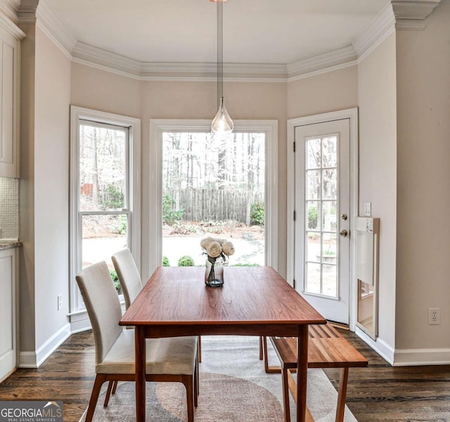 dining area with crown molding, dark wood-style flooring, and a wealth of natural light