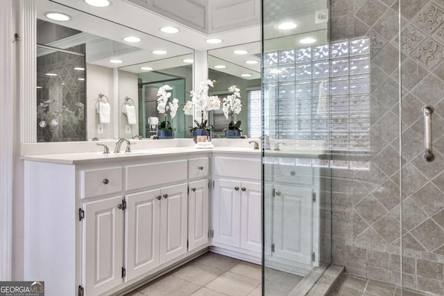 bathroom with tile patterned flooring, recessed lighting, a sink, a shower stall, and double vanity