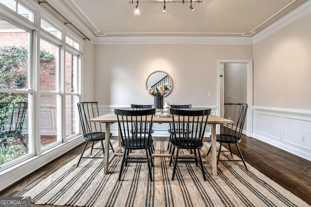 dining space featuring plenty of natural light, ornamental molding, and dark wood-type flooring