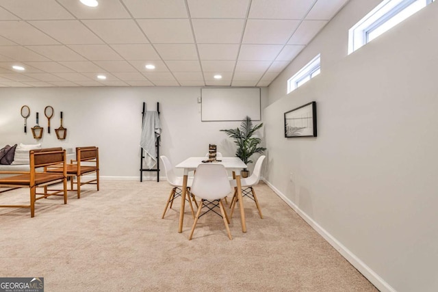 carpeted dining room with a paneled ceiling, baseboards, and recessed lighting