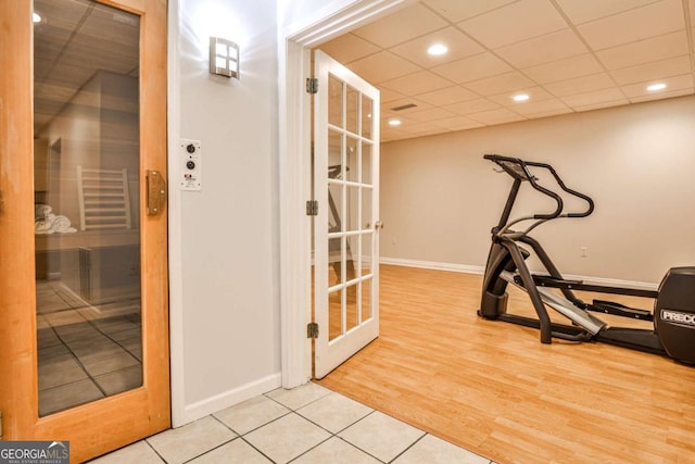 exercise room featuring baseboards, a sauna, wood finished floors, a paneled ceiling, and recessed lighting