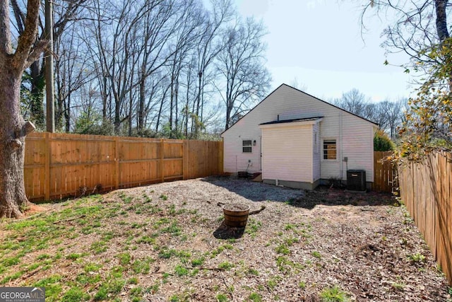 exterior space featuring central AC unit and a fenced backyard