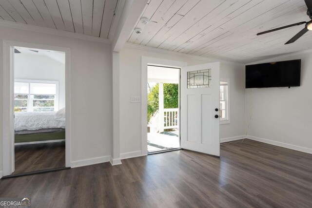 entrance foyer featuring ornamental molding, wood ceiling, baseboards, and wood finished floors