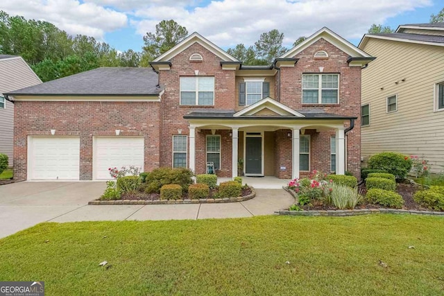 view of front of property featuring an attached garage, covered porch, brick siding, driveway, and a front lawn