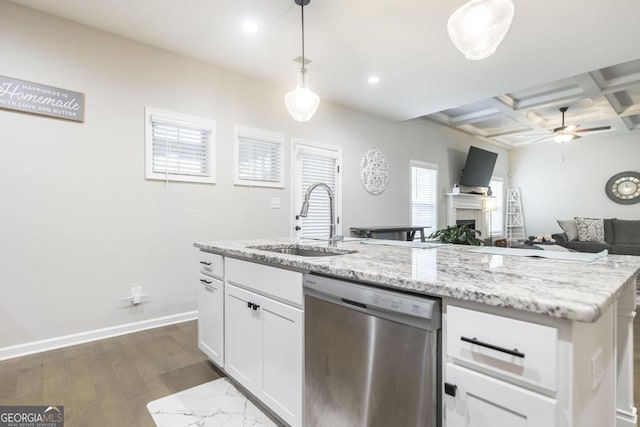 kitchen with open floor plan, white cabinets, a sink, coffered ceiling, and dishwasher