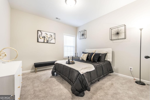 bedroom featuring light carpet, visible vents, and baseboards