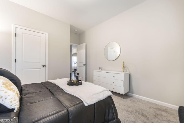 bedroom featuring baseboards and light colored carpet