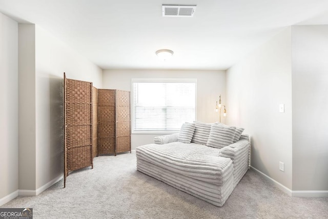 carpeted bedroom featuring baseboards and visible vents