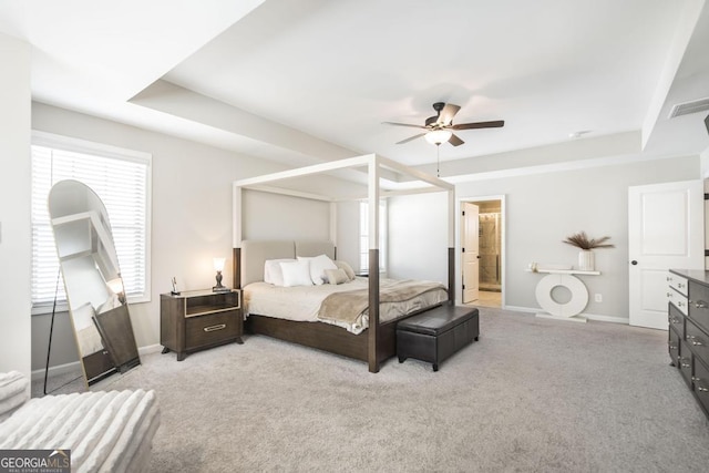 bedroom with light carpet, ceiling fan, visible vents, and baseboards