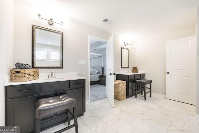 full bath featuring visible vents, connected bathroom, a sink, marble finish floor, and two vanities