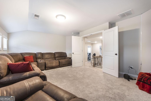 living area featuring lofted ceiling, baseboards, visible vents, and carpet flooring