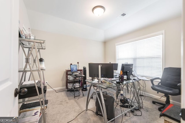 carpeted office space featuring visible vents and baseboards