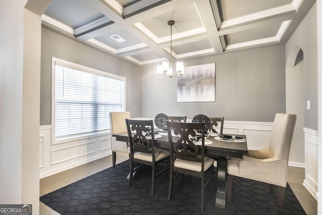 dining area with visible vents, arched walkways, dark wood-style floors, a chandelier, and beam ceiling