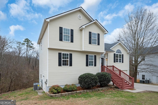 view of front facade with a front yard and central AC unit