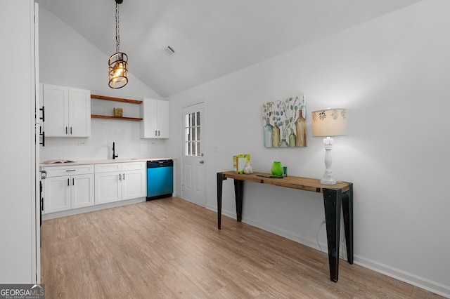 kitchen featuring dishwashing machine, open shelves, visible vents, and white cabinetry