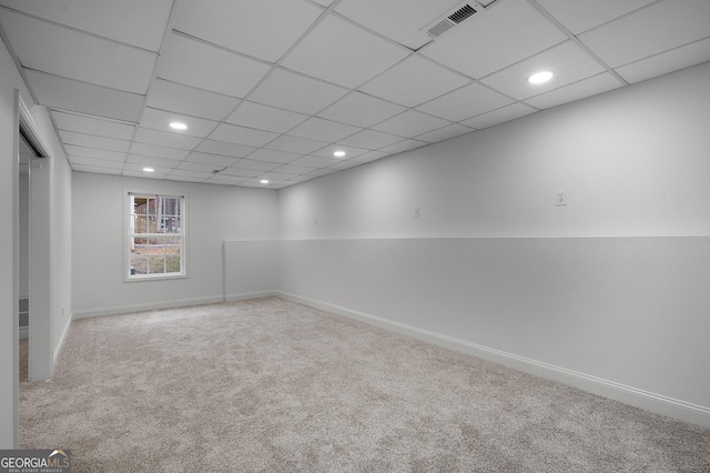 below grade area with carpet floors, recessed lighting, a drop ceiling, and baseboards