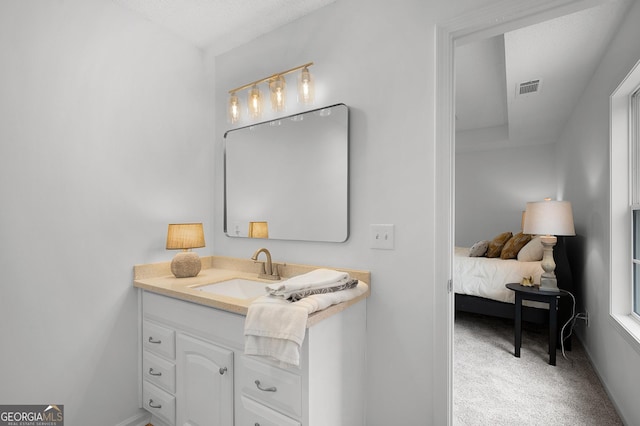 bathroom featuring vanity, visible vents, and baseboards