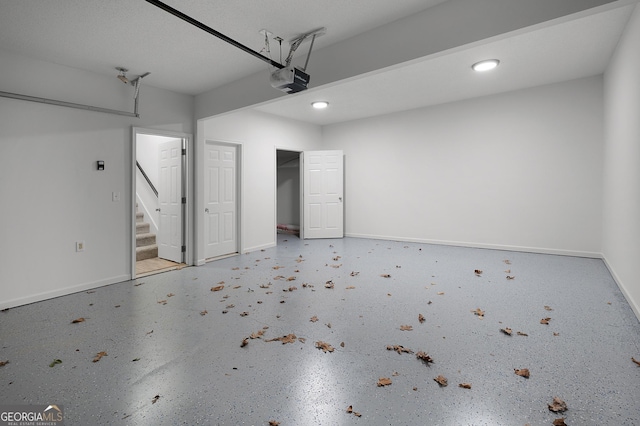 garage featuring baseboards and a garage door opener