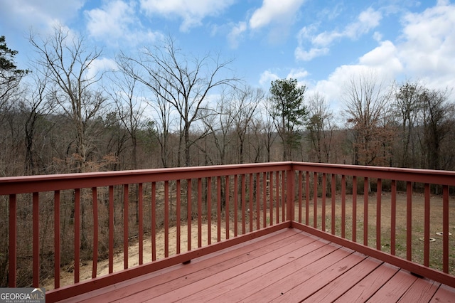 wooden deck with a wooded view