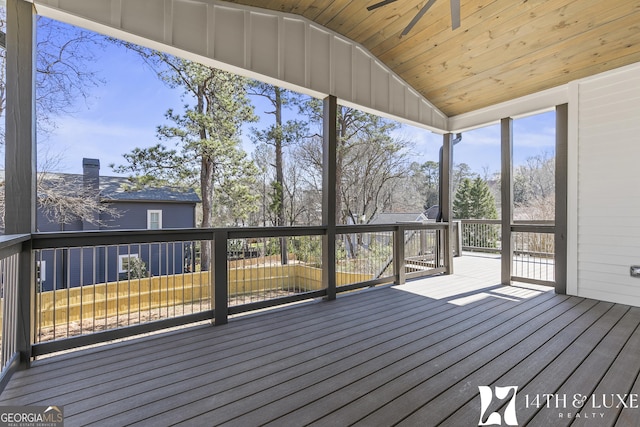 unfurnished sunroom with wooden ceiling, vaulted ceiling, and a ceiling fan