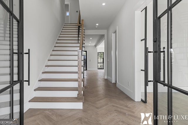 foyer entrance featuring recessed lighting, stairway, and baseboards