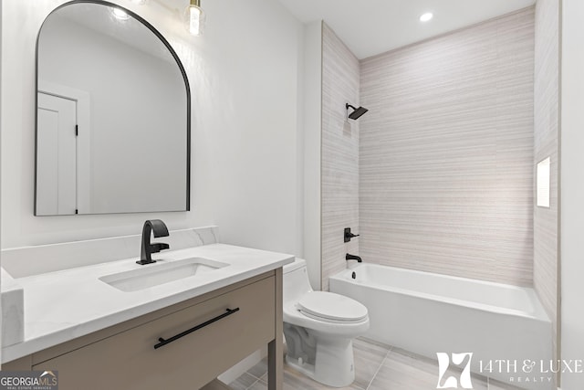 bathroom featuring toilet, bathtub / shower combination, and vanity