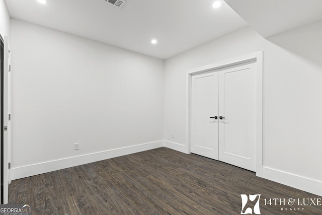 interior space featuring visible vents, baseboards, dark wood-style flooring, and recessed lighting