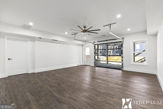 unfurnished living room featuring dark wood-style floors, recessed lighting, visible vents, a ceiling fan, and baseboards