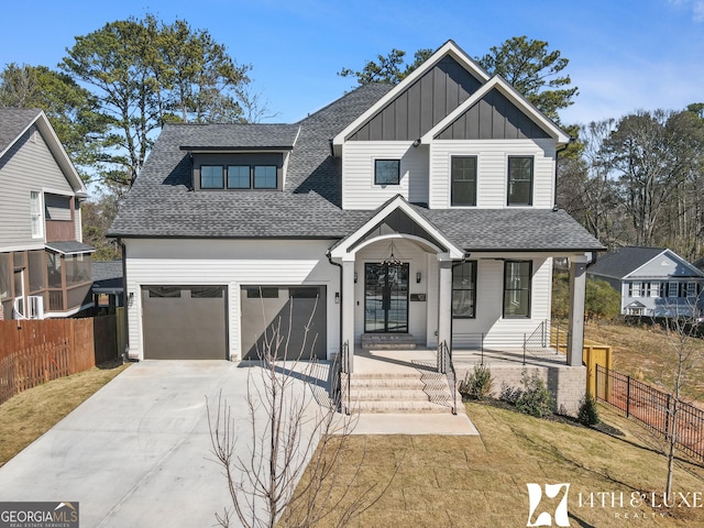 view of front of property featuring an attached garage, a shingled roof, fence, concrete driveway, and board and batten siding