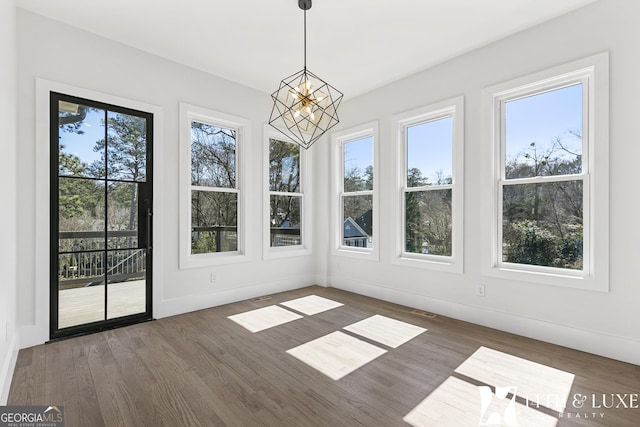 unfurnished sunroom with visible vents and a notable chandelier