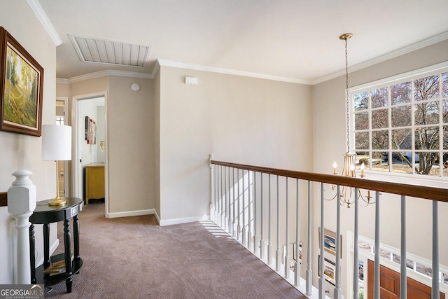 hallway with carpet, visible vents, baseboards, crown molding, and a notable chandelier