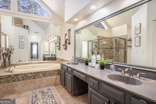 bathroom with lofted ceiling, a stall shower, and a sink