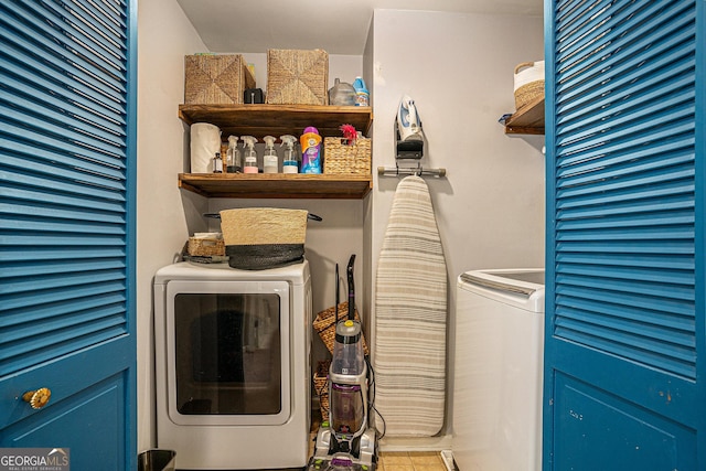 clothes washing area featuring washer / dryer and laundry area