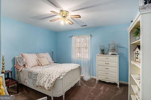 bedroom featuring baseboards, visible vents, dark carpet, and ceiling fan