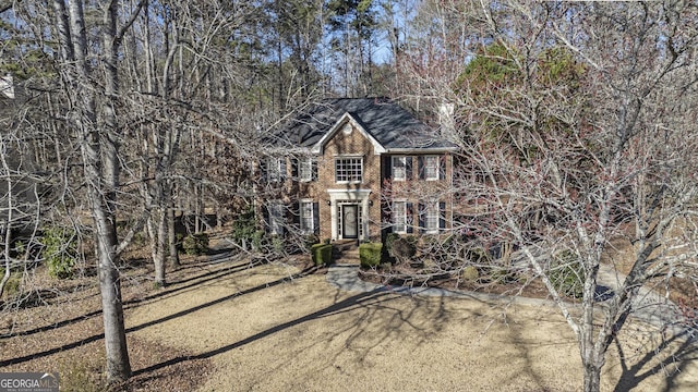 colonial-style house featuring brick siding