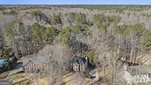 birds eye view of property with a forest view