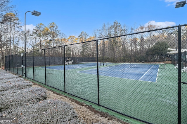 view of tennis court with fence