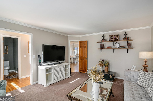 living room featuring carpet flooring, baseboards, and ornamental molding