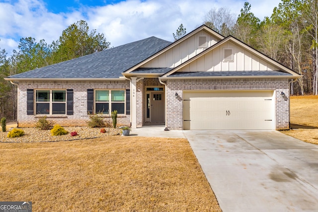 craftsman-style house featuring a garage, a front yard, brick siding, and driveway