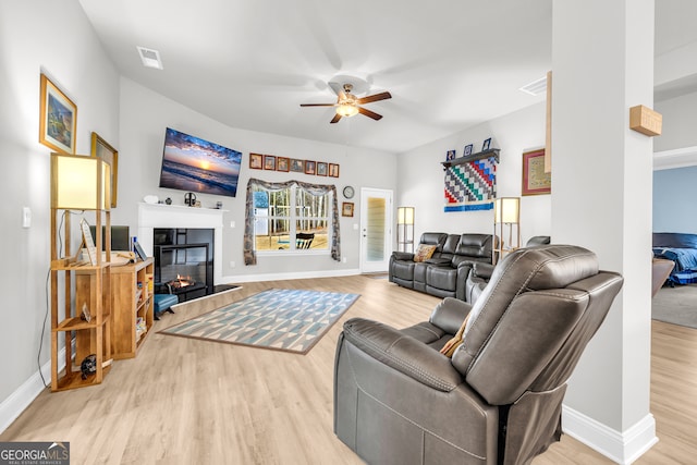 104 Eagle Heights Dr, Maysville, GA 30558 - living area featuring baseboards, visible vents, a ceiling fan, a glass covered fireplace, and wood finished floors