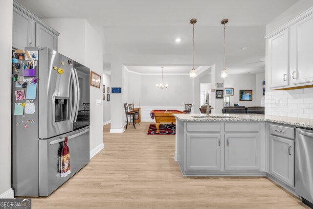104 Eagle Heights Dr, Maysville, GA 30558 - kitchen with backsplash, gray cabinets, light wood-style floors, and appliances with stainless steel finishes